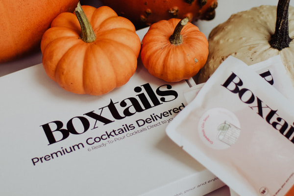 Box and sachets with Boxtails logo alongside pumpkins