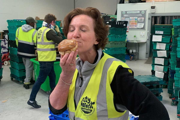 City Harvest volunteer enjoying a doughnut