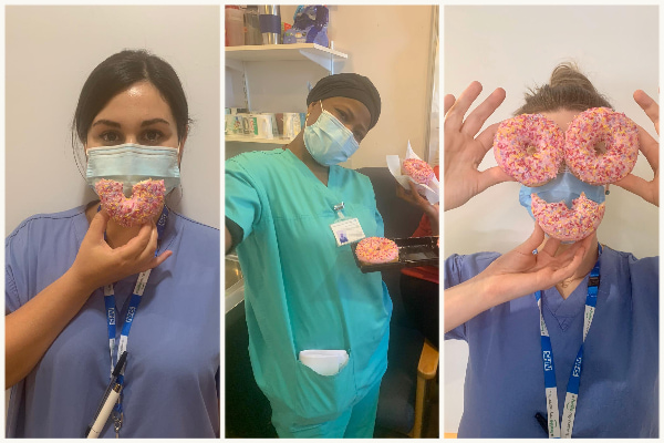 Three NHS workers with doughnuts creating smiley faces