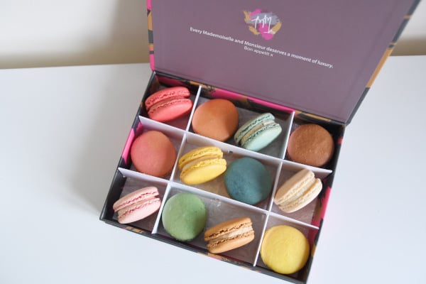 pastel-coloured macarons in a box