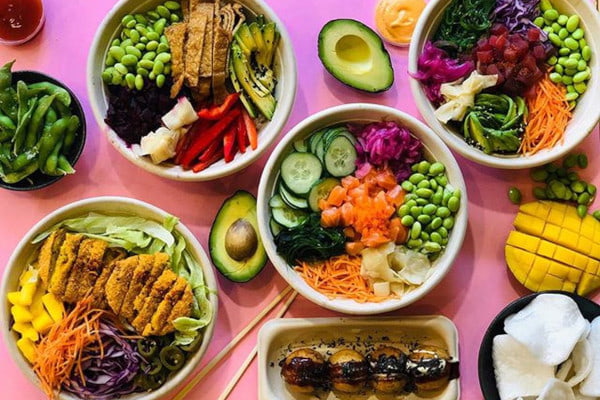 Poke bowls on a bright pink surface