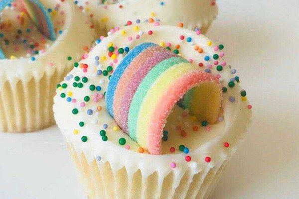 Cupcakes with rainbow candy and sprinkles on top