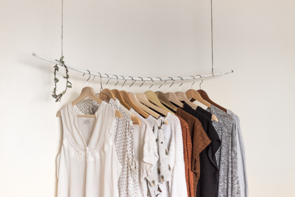 Hanging rail with neutral coloured clothes on