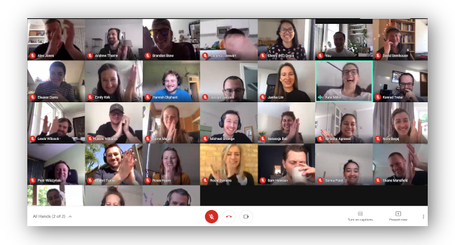 Screenshot of video call between 32 people all clapping