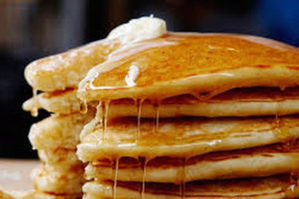 Pancakes stacked up with butter and syrup