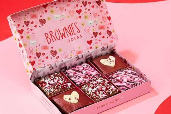 Lola's branded box with lots of hearts on filled with Valentine's themed decorated brownies