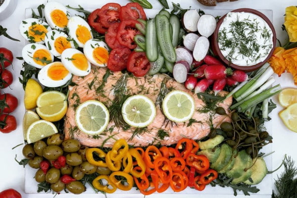 Platter including salmon, veggies, eggs and dip